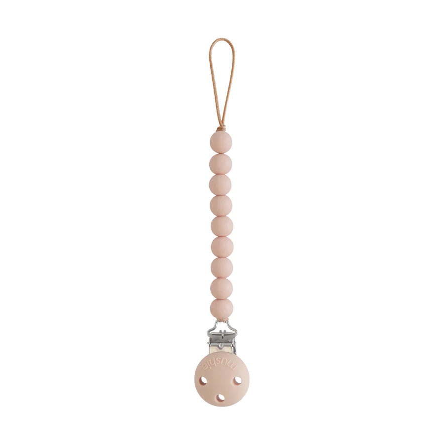 Attache tétine en silicone rose pour bébé de la marque Mushie chez Le béguin de Charlie
